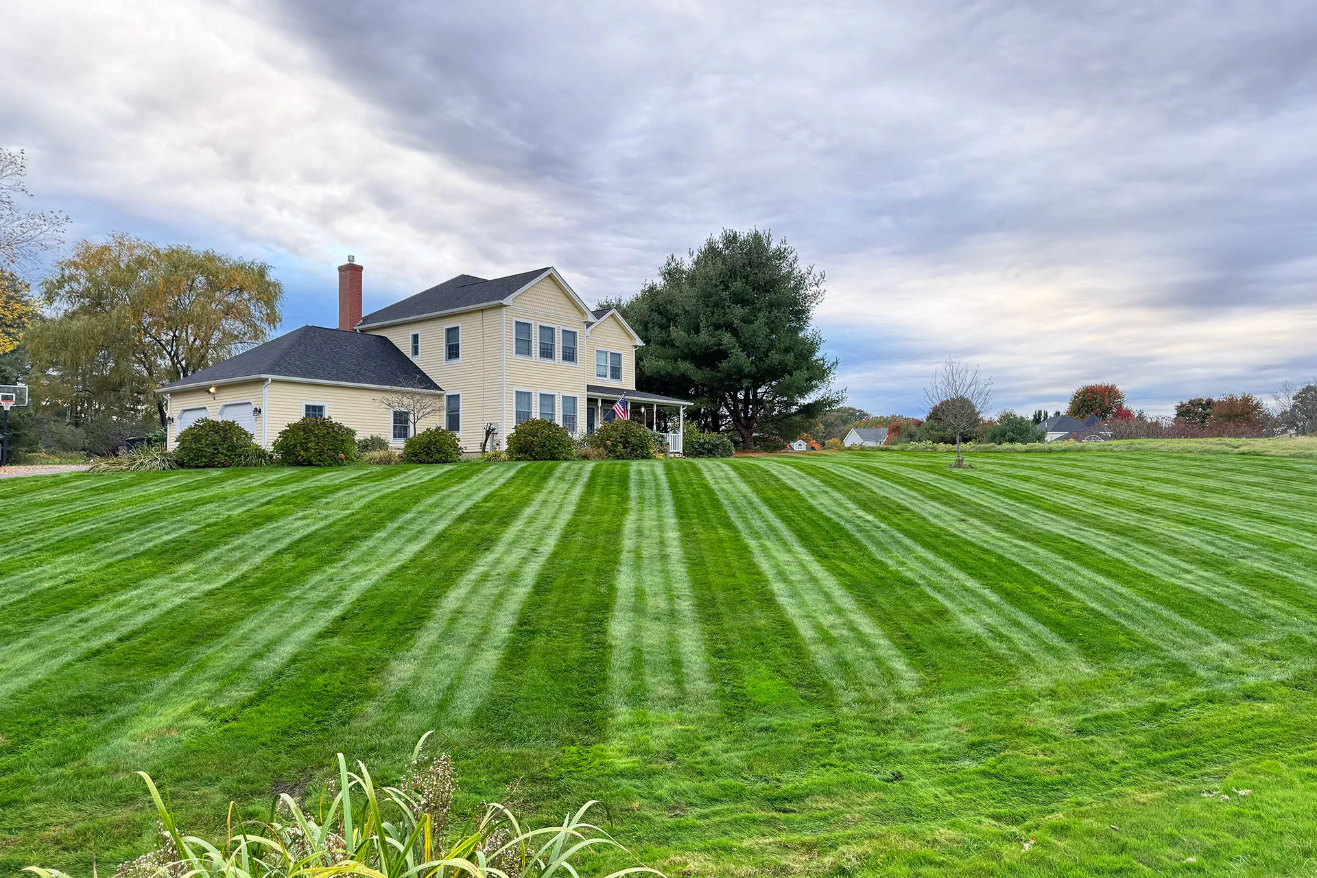 A house with a freshly mowed lawn after a lawn care service near me